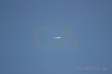 Blue sky flying airplane.