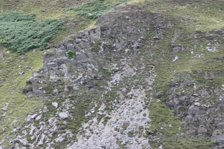 Gray cliff green rock.