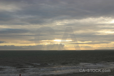 Gray coast sky water sea.