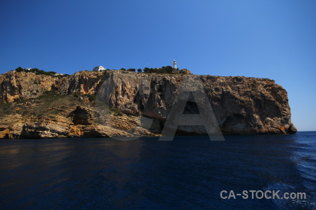 Lighthouse rock spain sea cliff.