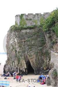 Person cliff white rock green.