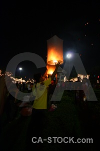 Person loi krathong festival flame light.