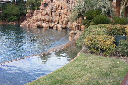 Rock cliff fountain water pool.