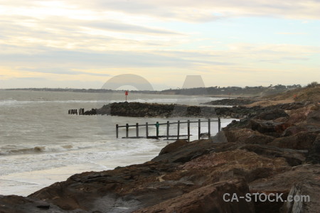 Rock coast sea white water.