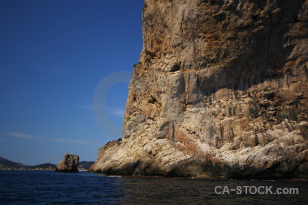 Sea blue javea rock cliff.