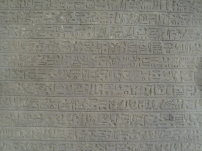 Texture hieroglyph gray wall.